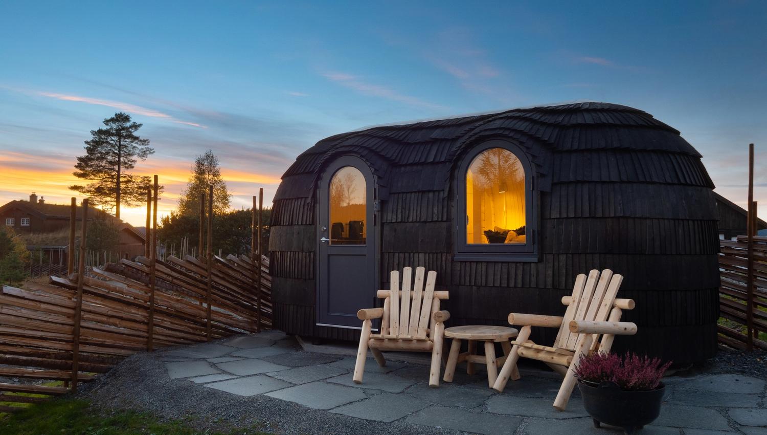 small cabin with 2 chairs in front