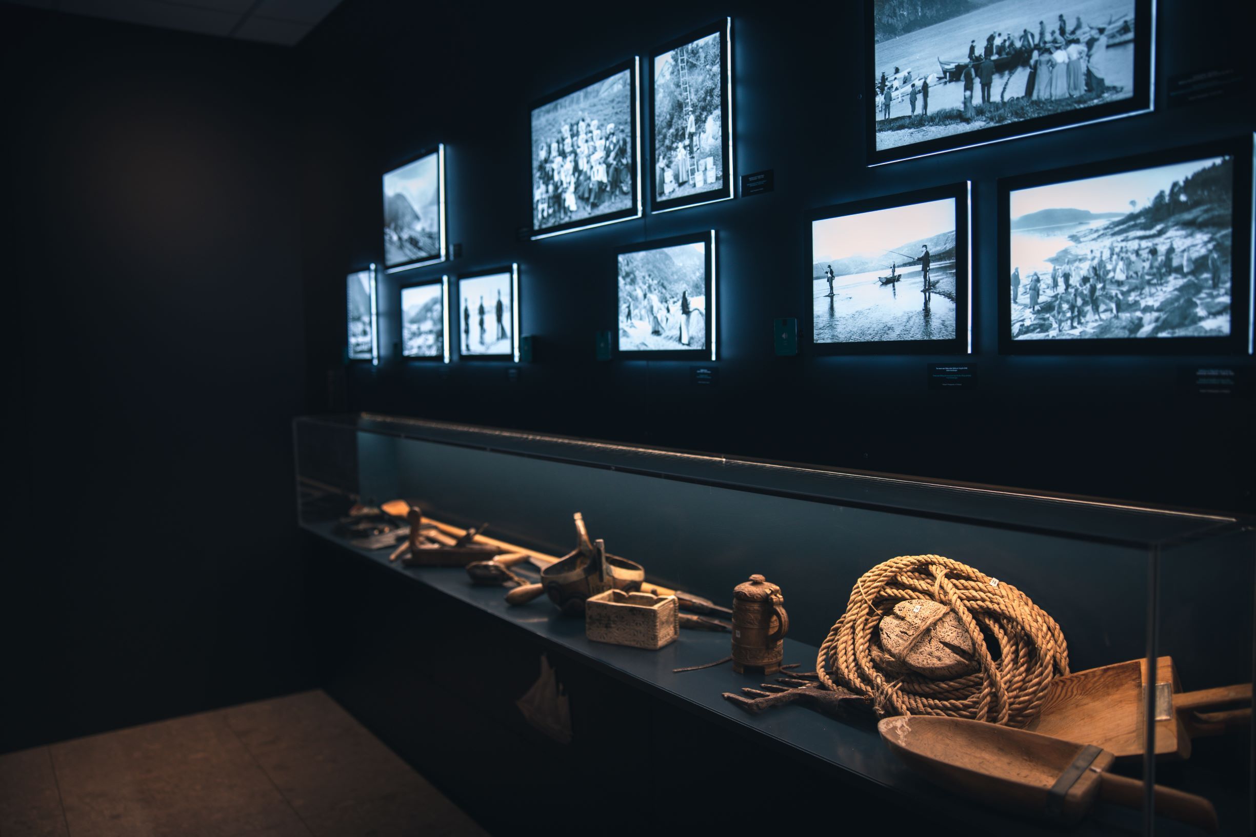 Exhibition at Hardanger Aquaculture Centre showcasing historic photos and fishing tools.