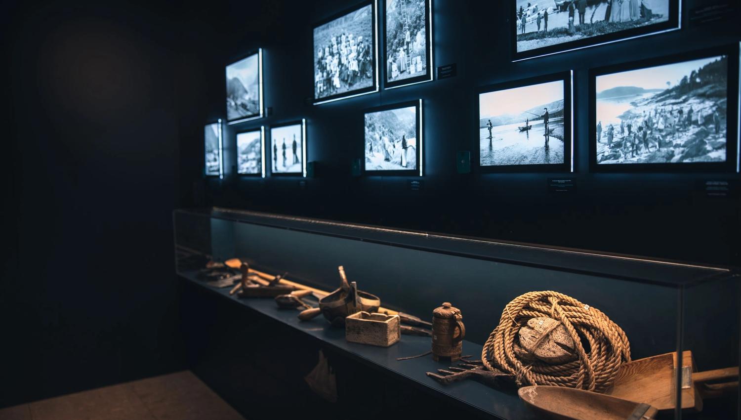 Exhibition at Hardanger Aquaculture Centre showcasing historic photos and fishing tools.
