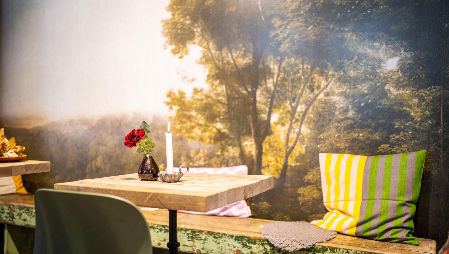 a table and bench at a cafe