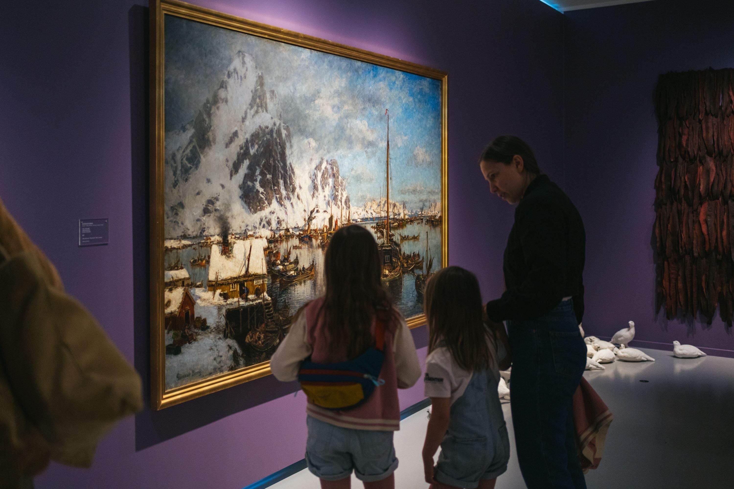 Guests viewing a large painting