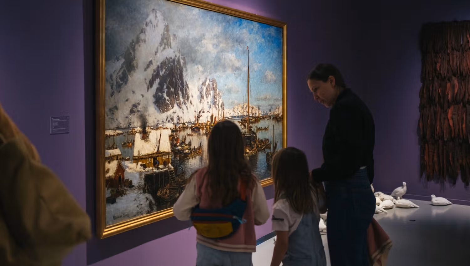 Guests viewing a large painting
