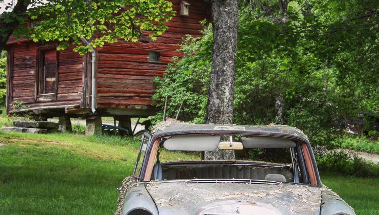 An old car in front of an old building