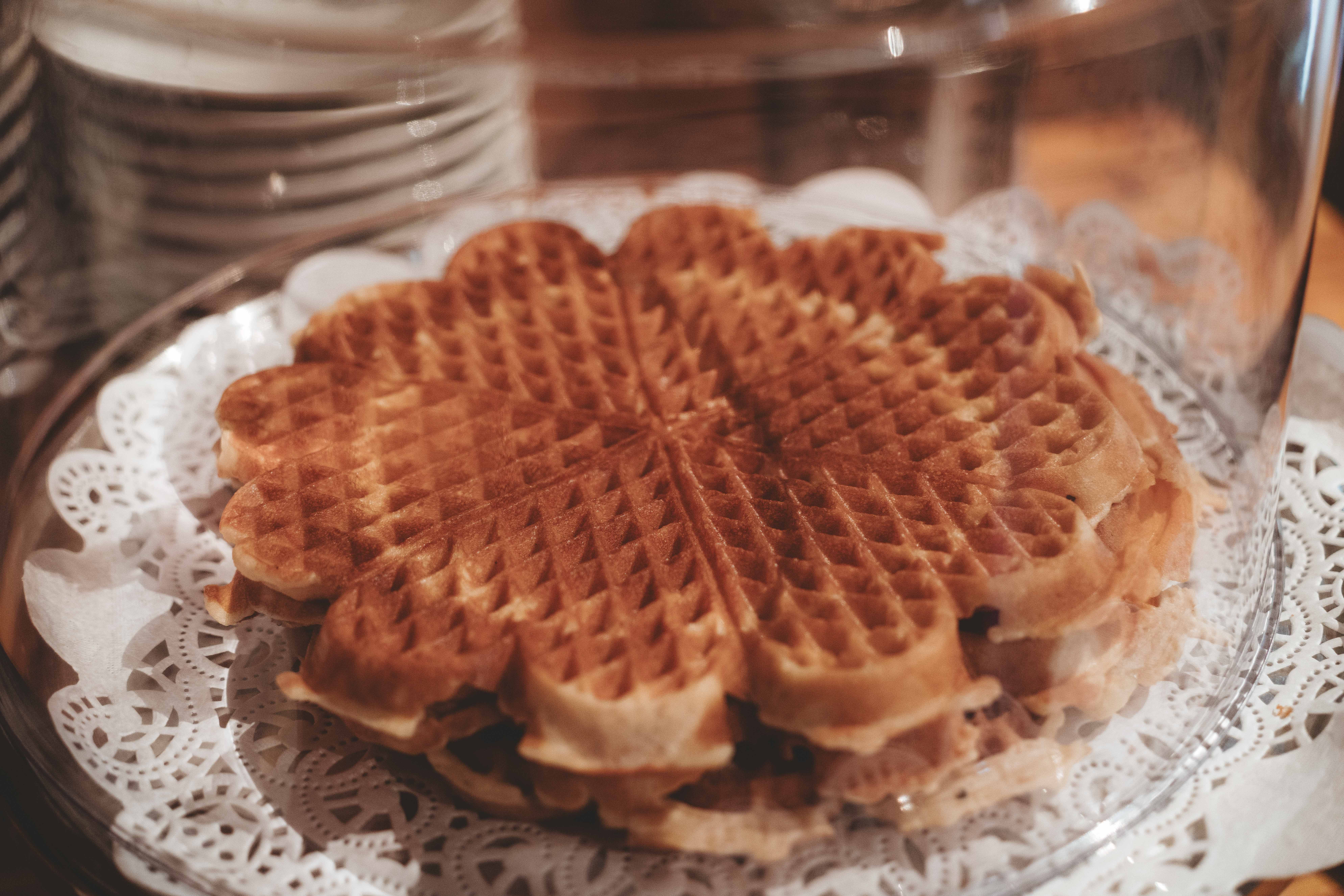 A plate with a stack of norwegian waffles.