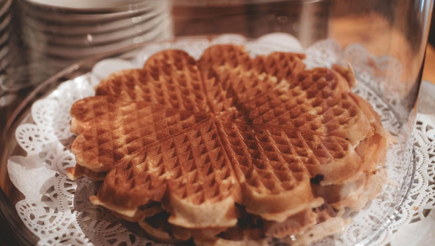 A plate with a stack of norwegian waffles.