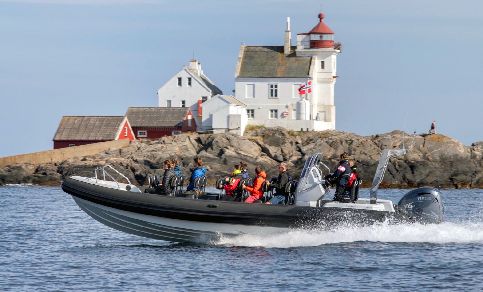 RIB driving past Grønningen lighthouse outside Kristiansand