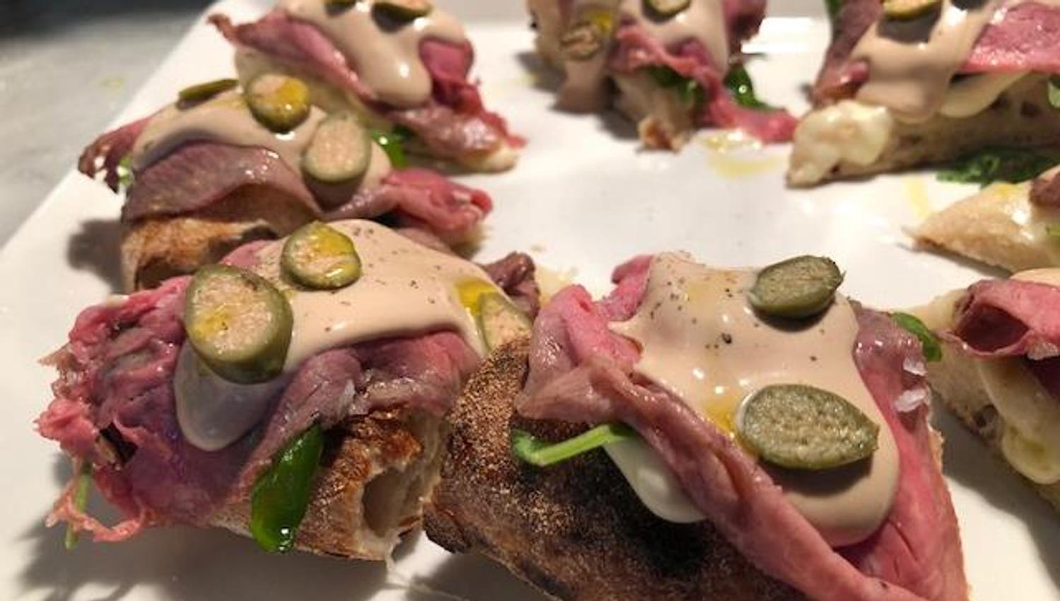 Detail of pizza with Vitello Tonnato topping.