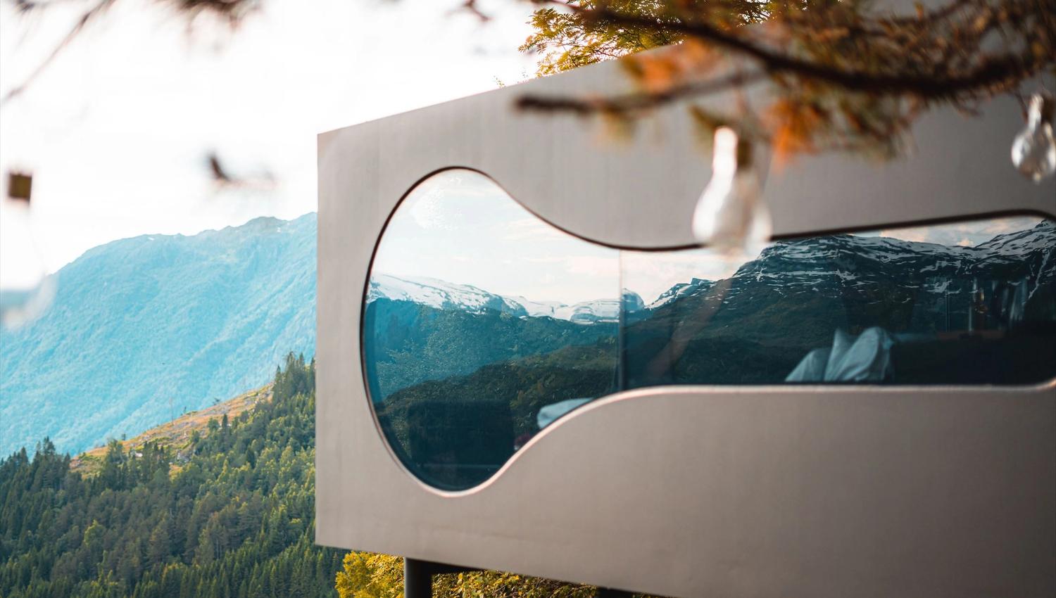 Stunning panoramic view from the Birdbox cabin at Skaara Living on Lotsberg in Nordfjord, surrounded by mountains and fjord landscape.