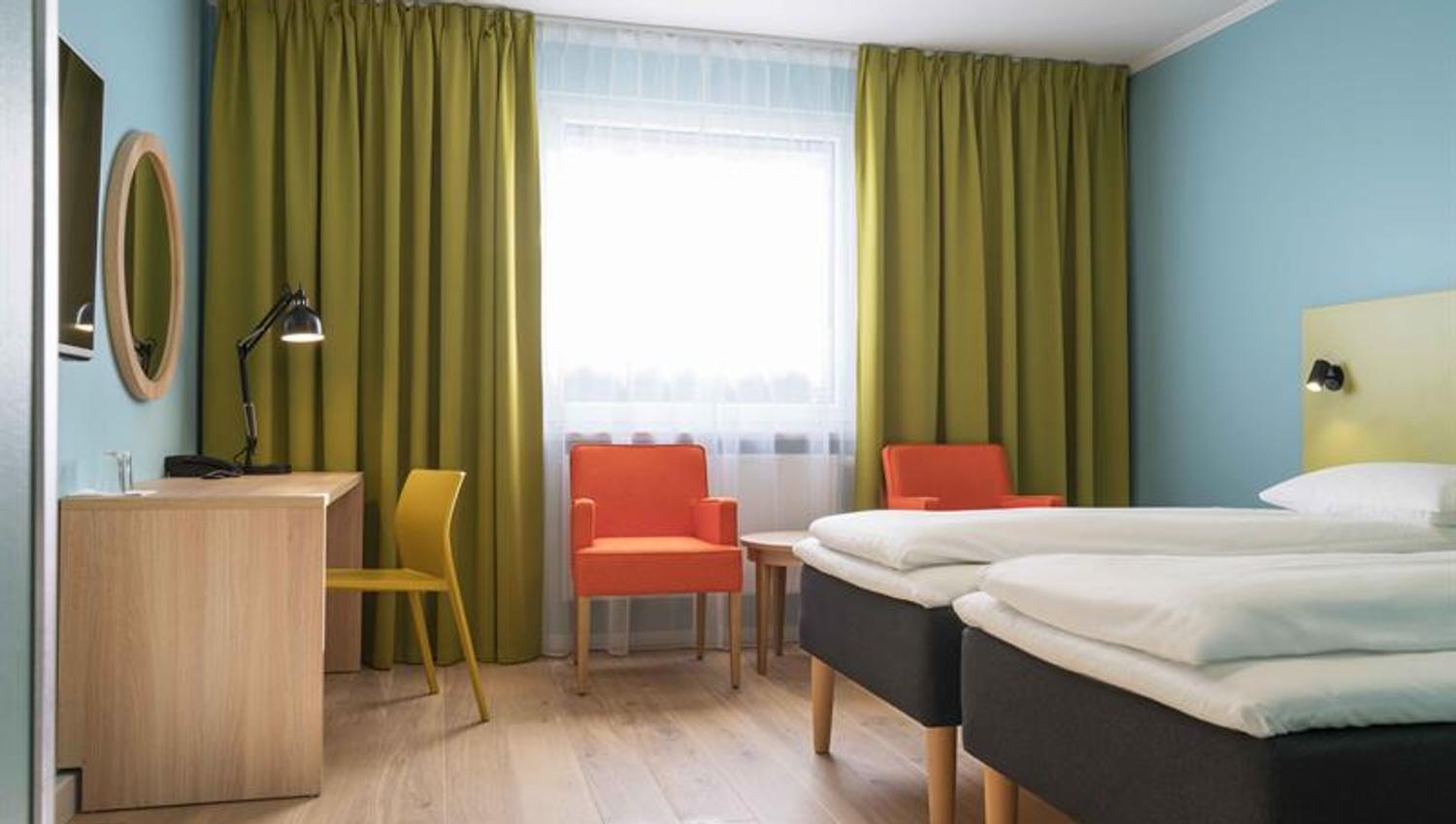 double room with twin beds and orange chairs
