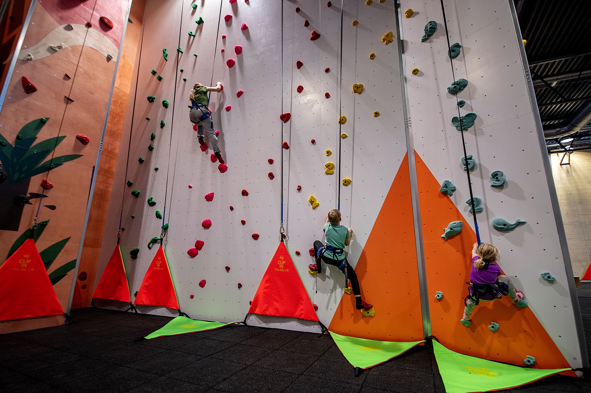 Children climb the climbing wall