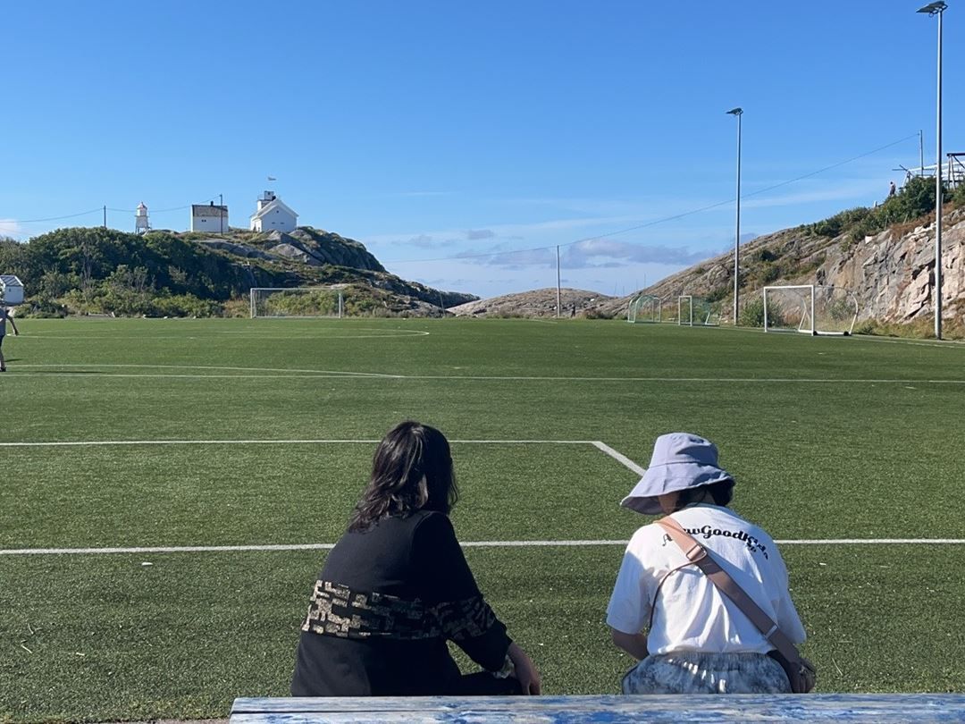 Two guests sitting near a park
