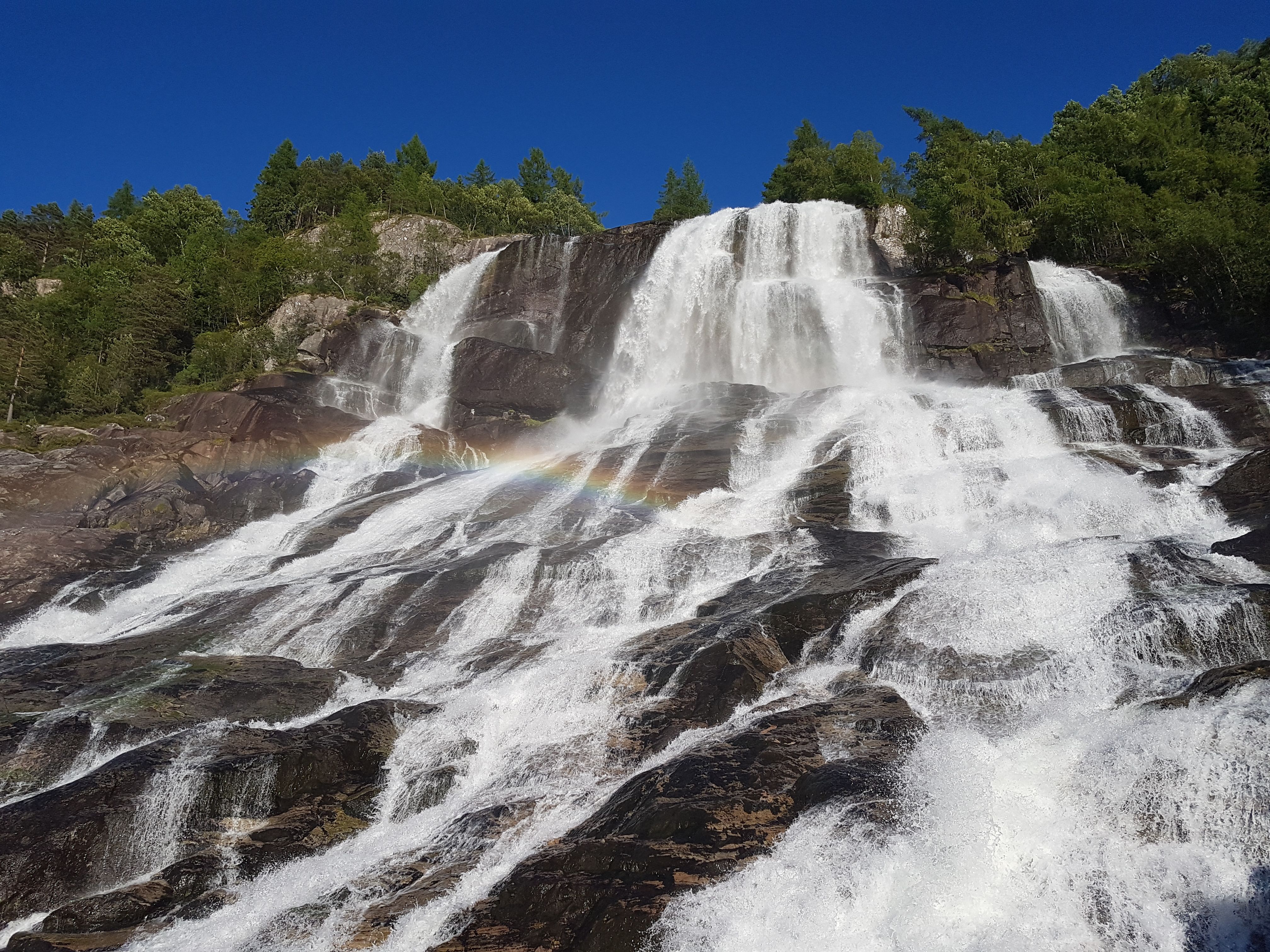 Close-up of Furubergsfossen – The powerful flow of Furubergsfossen highlighted, with a beautiful rainbow shimmer in the water.
