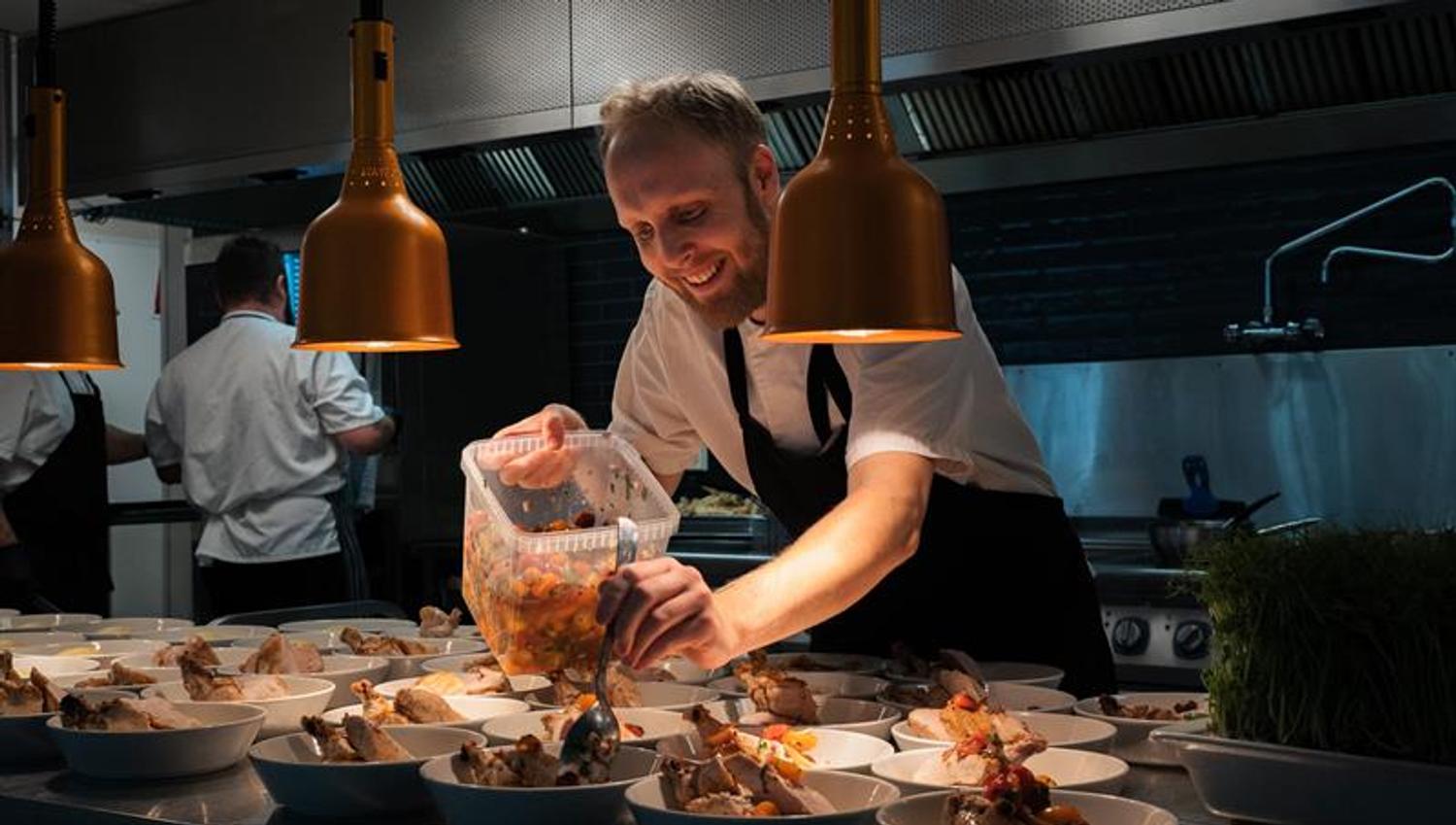Chef puts food on plates