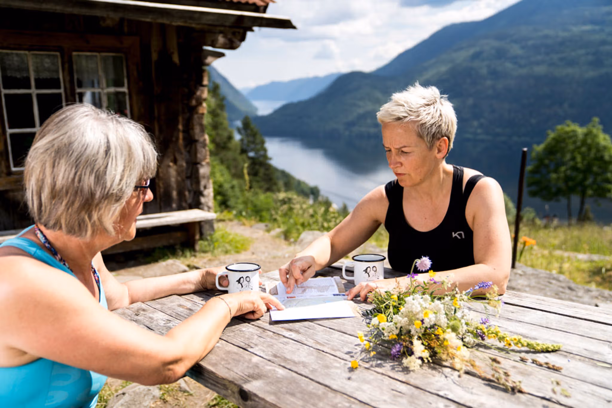 2 ladies sitting at a table at Rui Square looking at a map