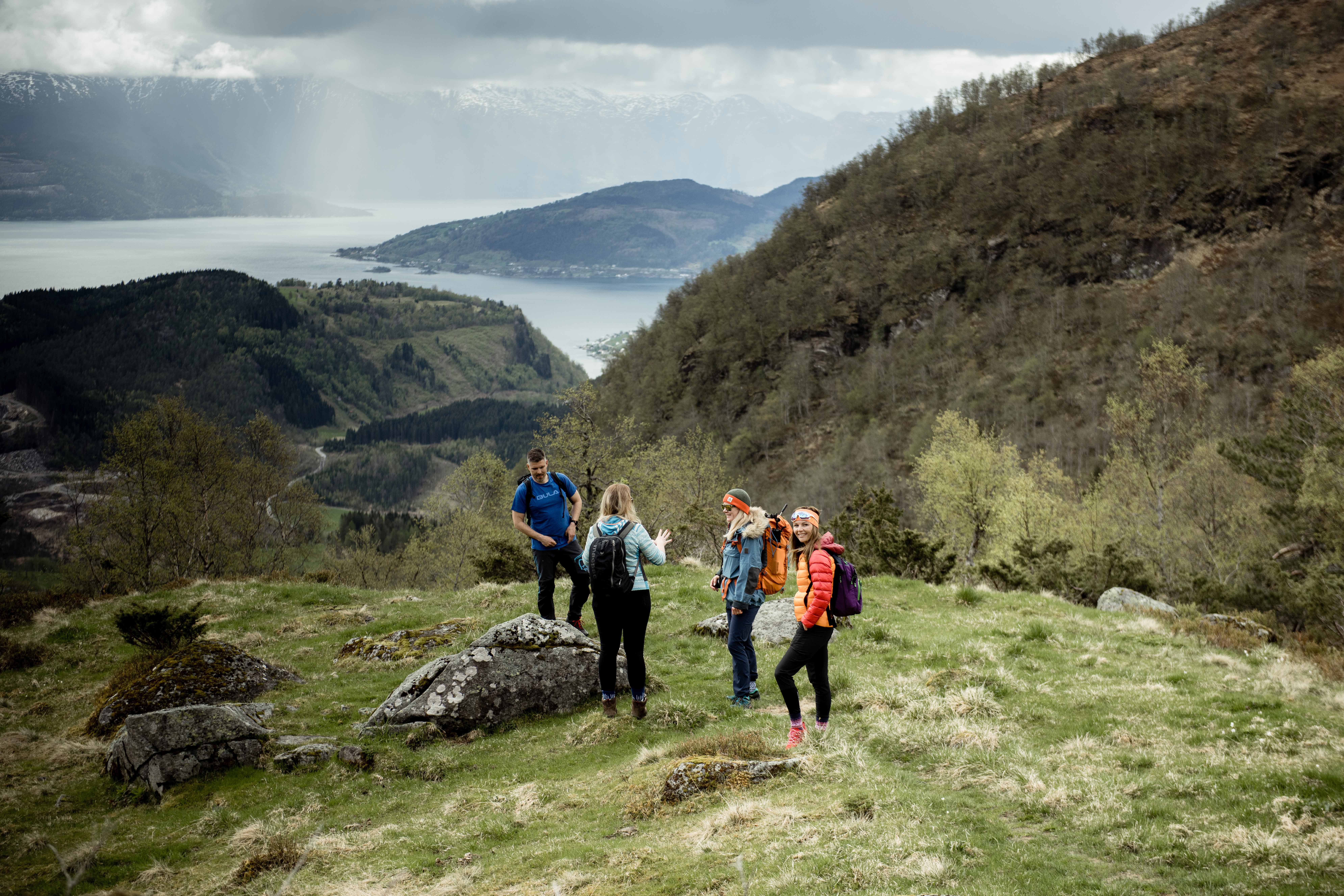 Group on a guided hike in Hardanger, surrounded by dramatic mountain and fjord scenery.