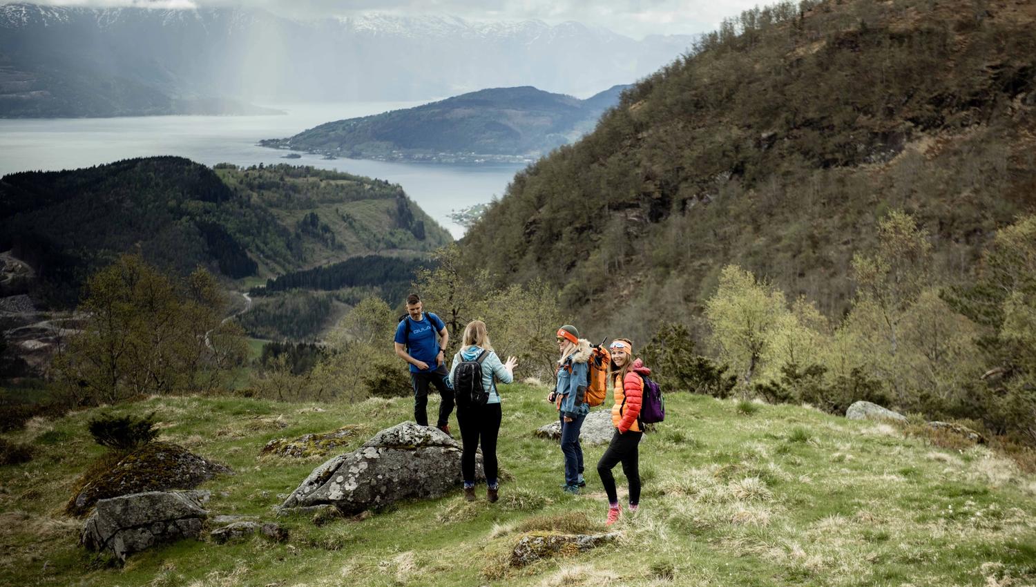 Group on a guided hike in Hardanger, surrounded by dramatic mountain and fjord scenery.