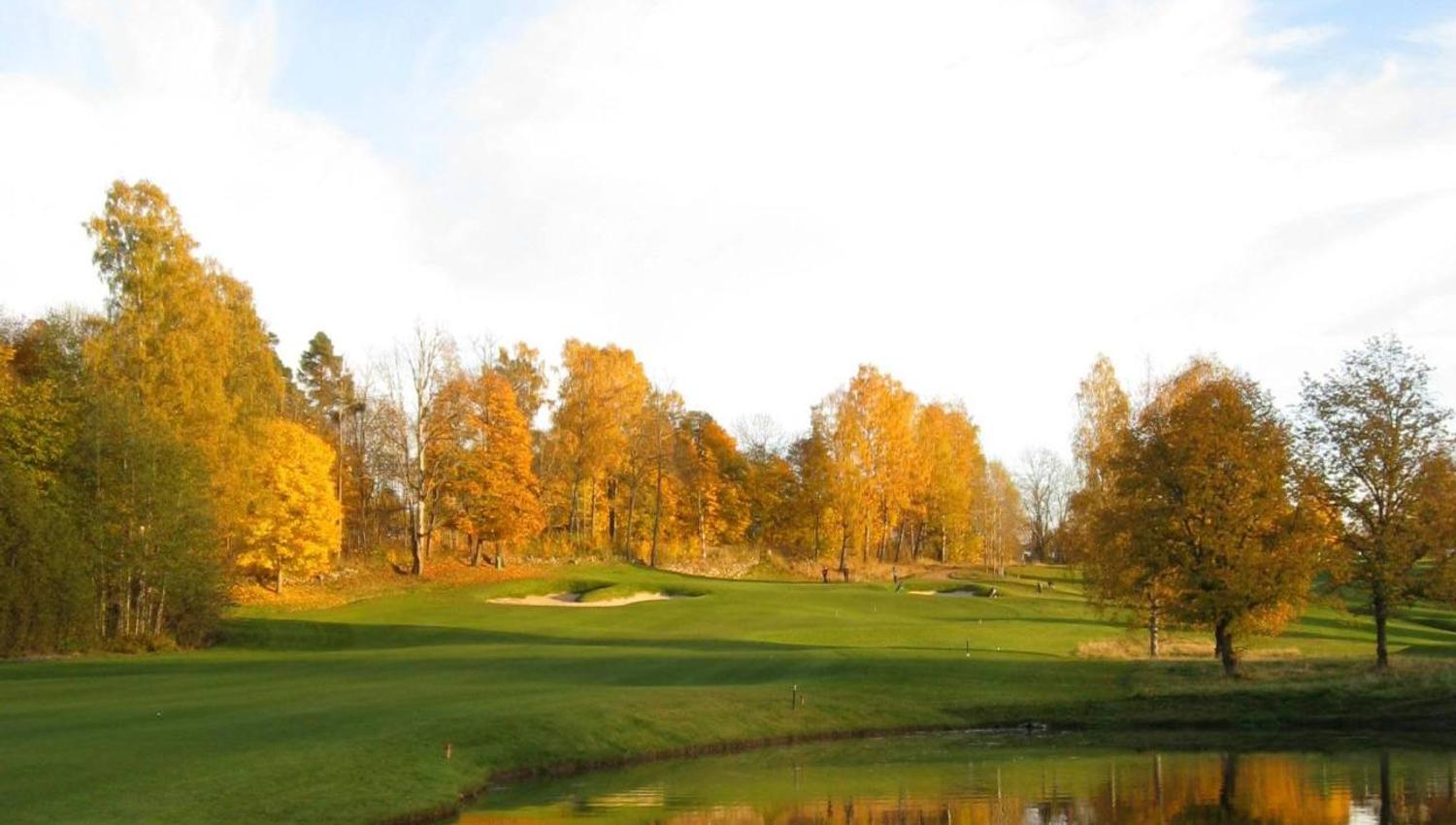 the golf course in autumn with deciduous trees in autumn colours