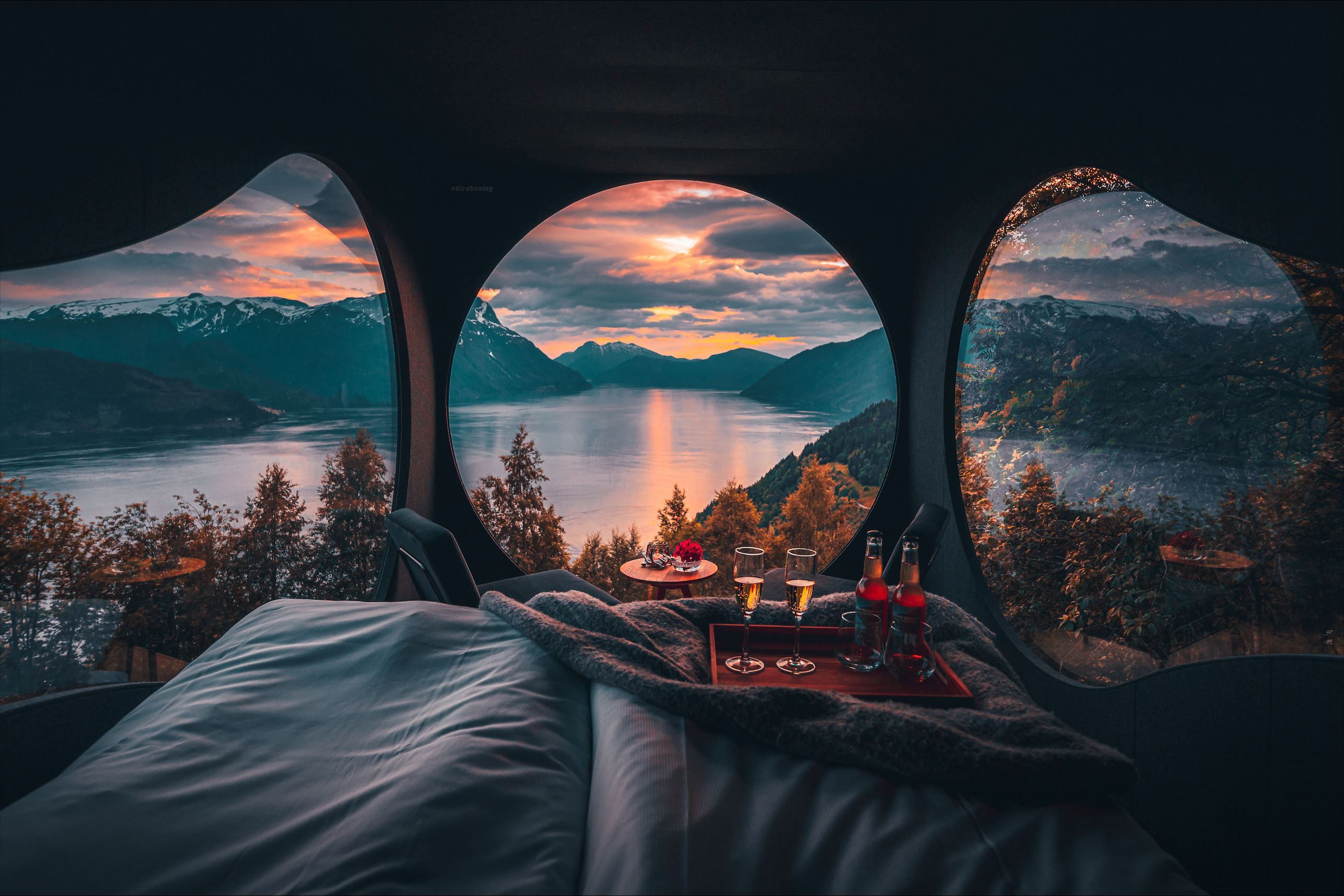 Stunning panoramic view from the Birdbox cabin at Skaara Living on Lotsberg in Nordfjord, surrounded by mountains and fjord landscape.