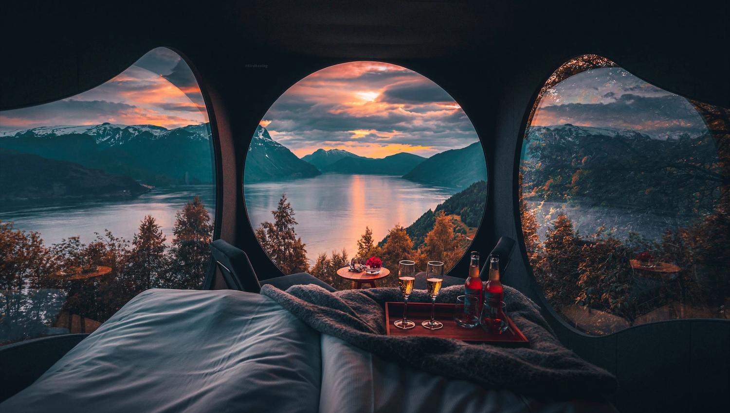 Stunning panoramic view from the Birdbox cabin at Skaara Living on Lotsberg in Nordfjord, surrounded by mountains and fjord landscape.