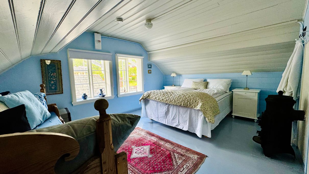 The Blue Room at Kramsjø Guesthouse – bright and peaceful with nostalgic charm and garden view.