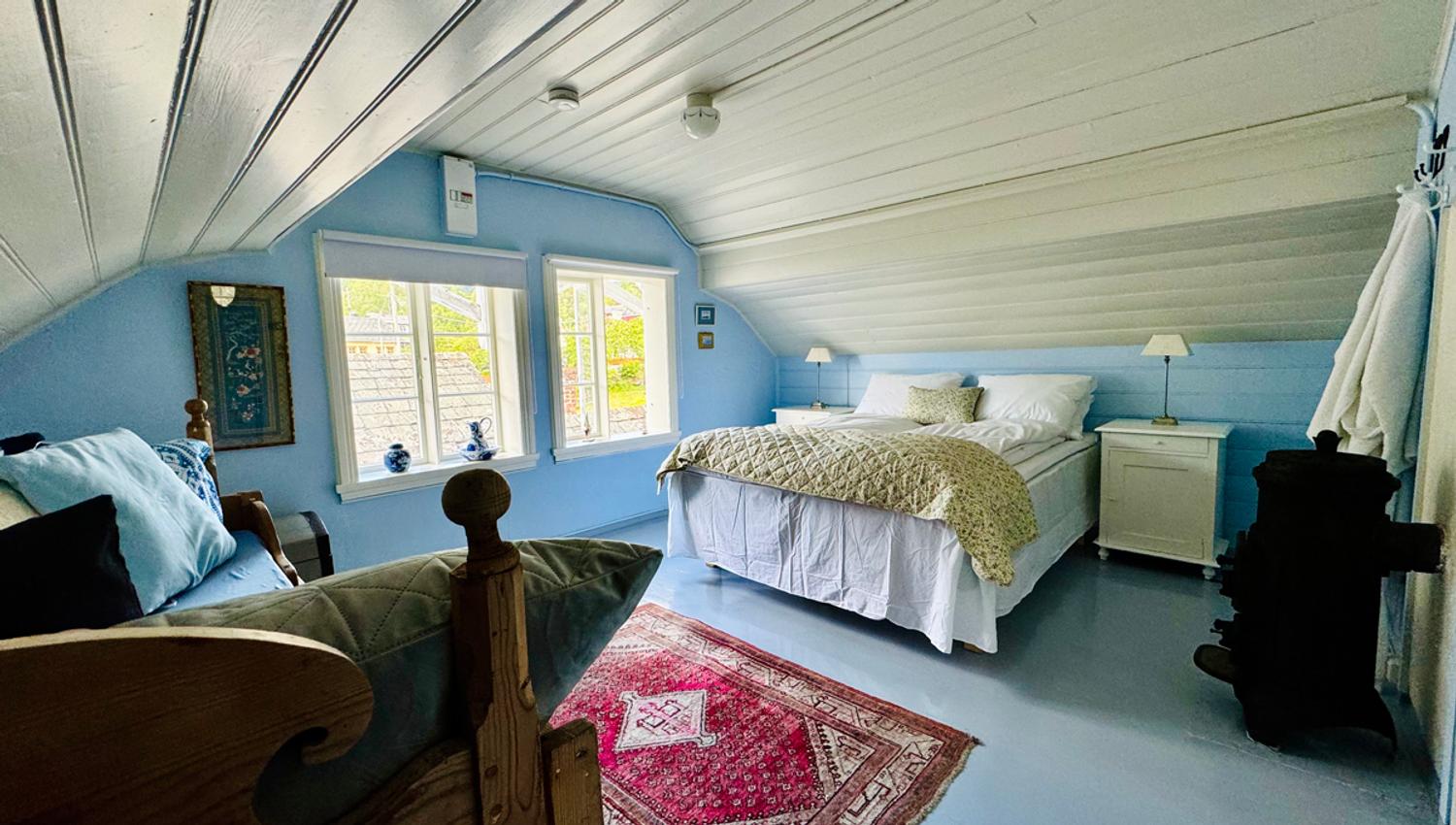 The Blue Room at Kramsjø Guesthouse – bright and peaceful with nostalgic charm and garden view.