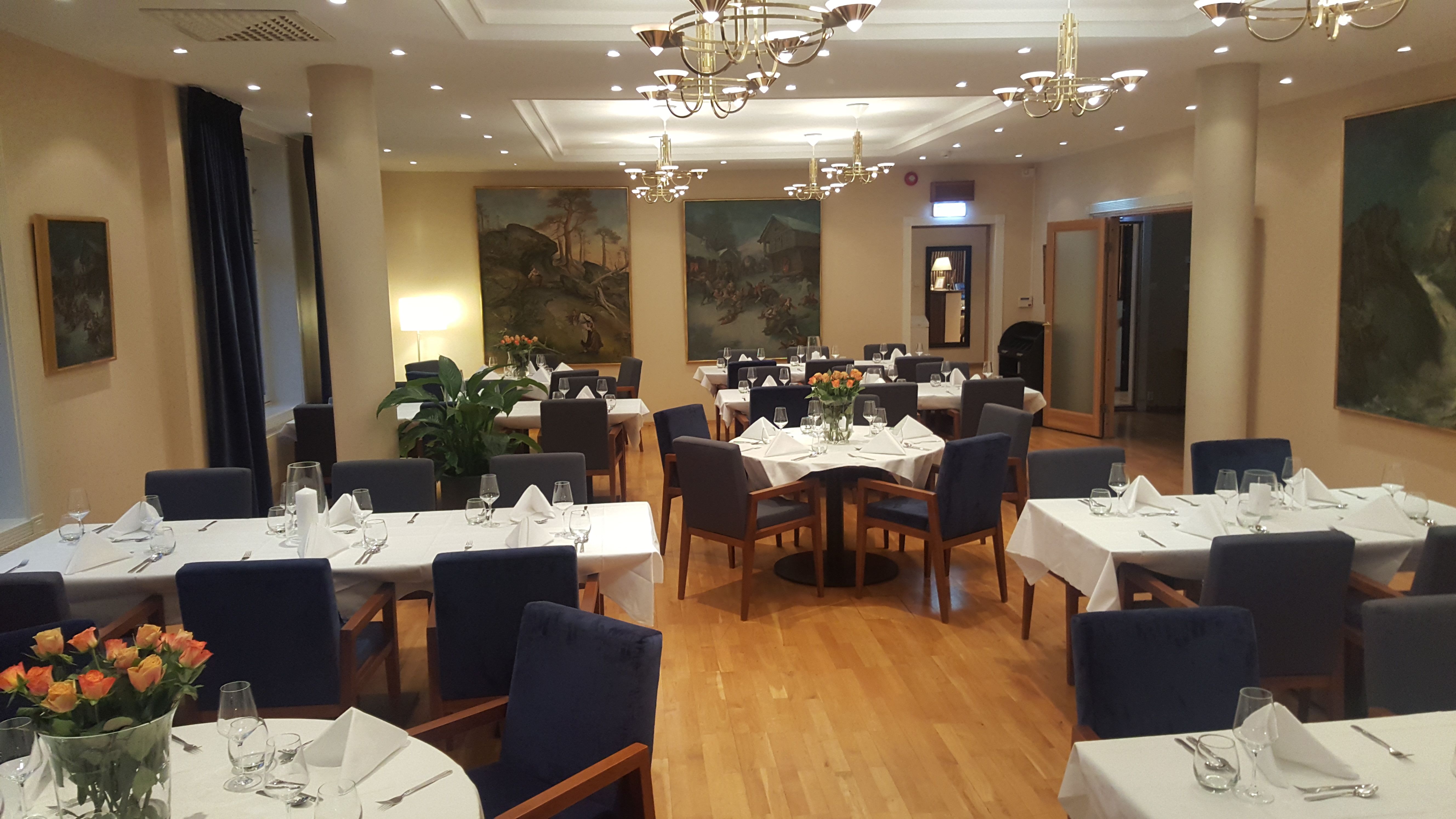 Multiple tables set for dinner at a hotel. 