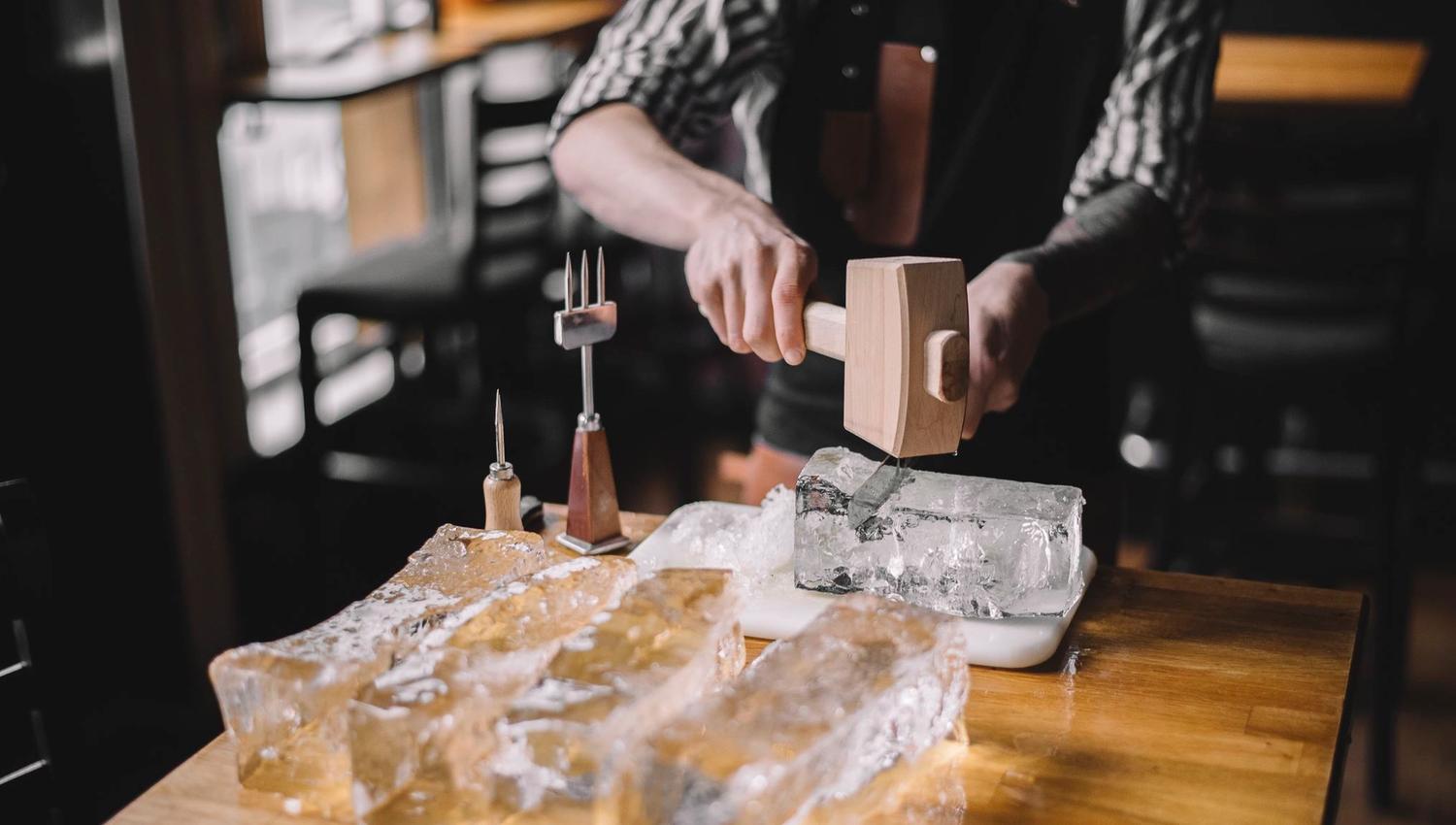Bartender cutting ice at Bardus Bar.