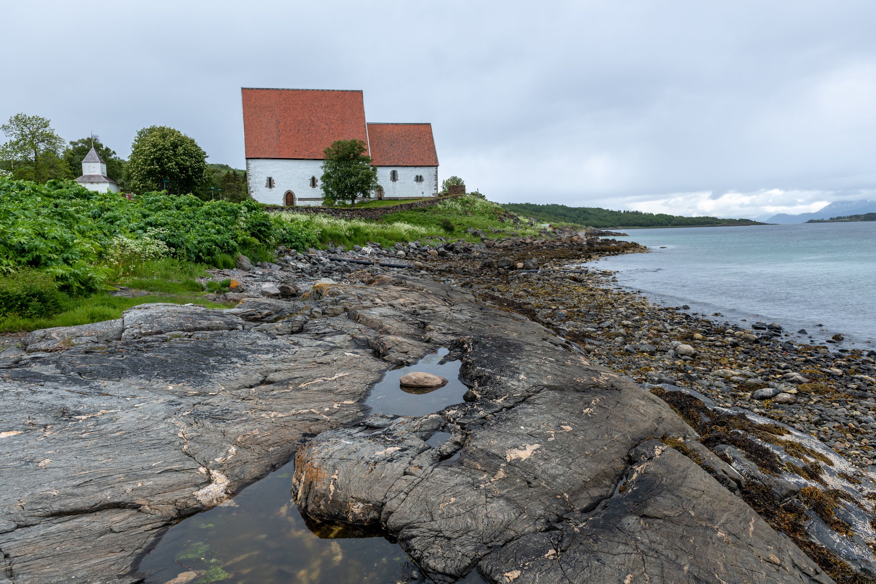 Arcticoncepts-Harstad-Trondenes medieval church-fjord-water-foto Dag Roland