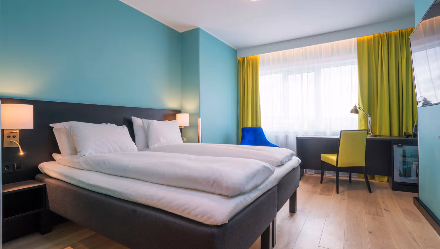 Colorful twin room with bed and desk