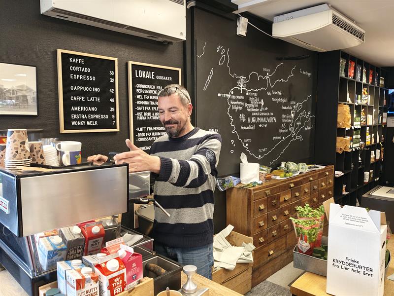 Man making coffee behind the counter