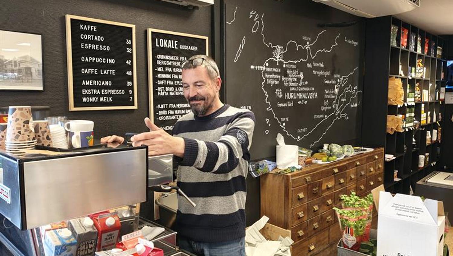 Man making coffee behind the counter