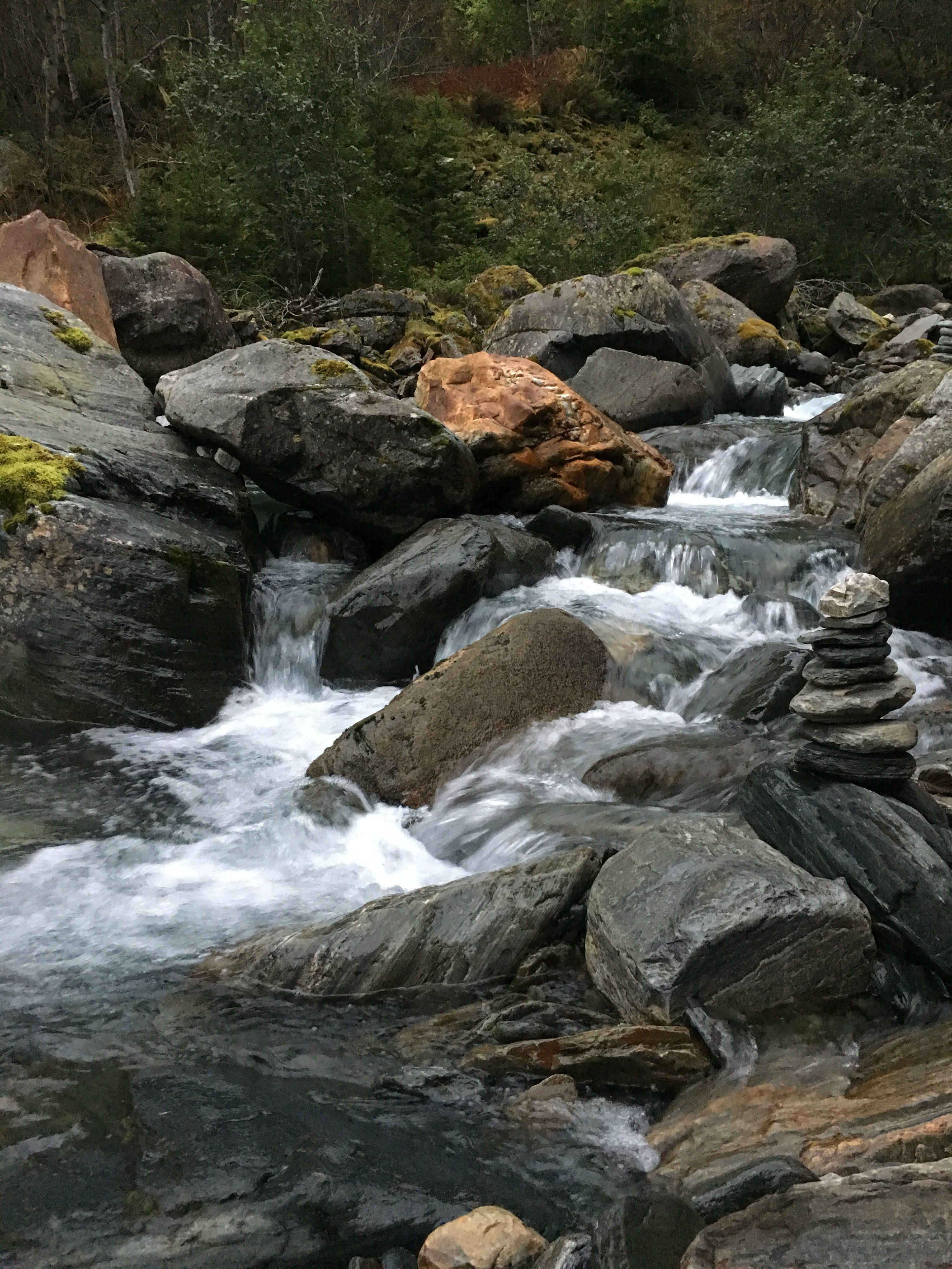 Mountain stream with small cascades and smooth rocks in Elvedalen, Lofthus, Hardanger.