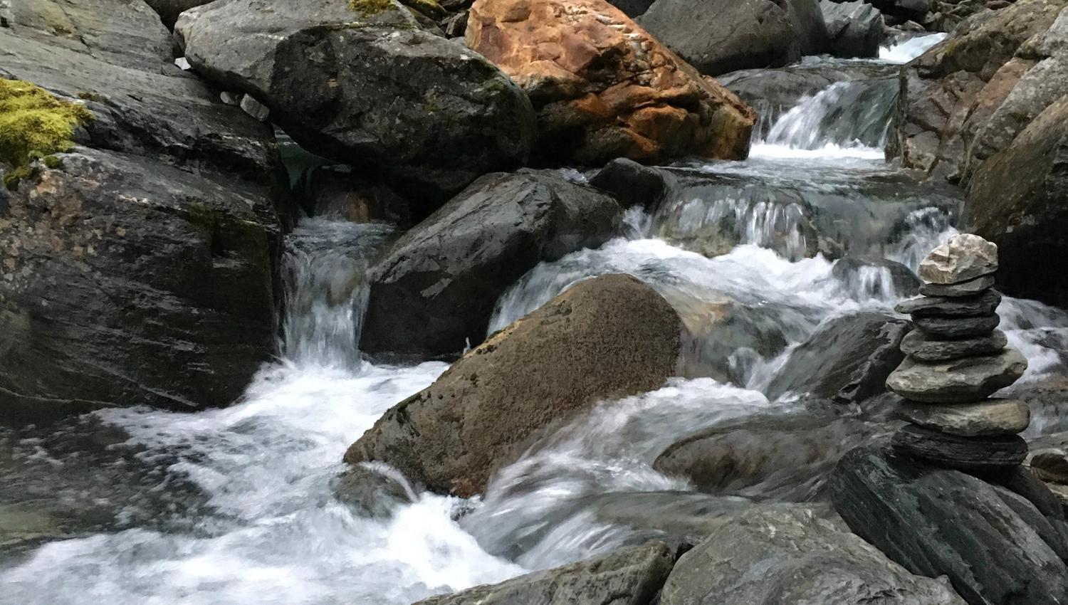 Mountain stream with small cascades and smooth rocks in Elvedalen, Lofthus, Hardanger.