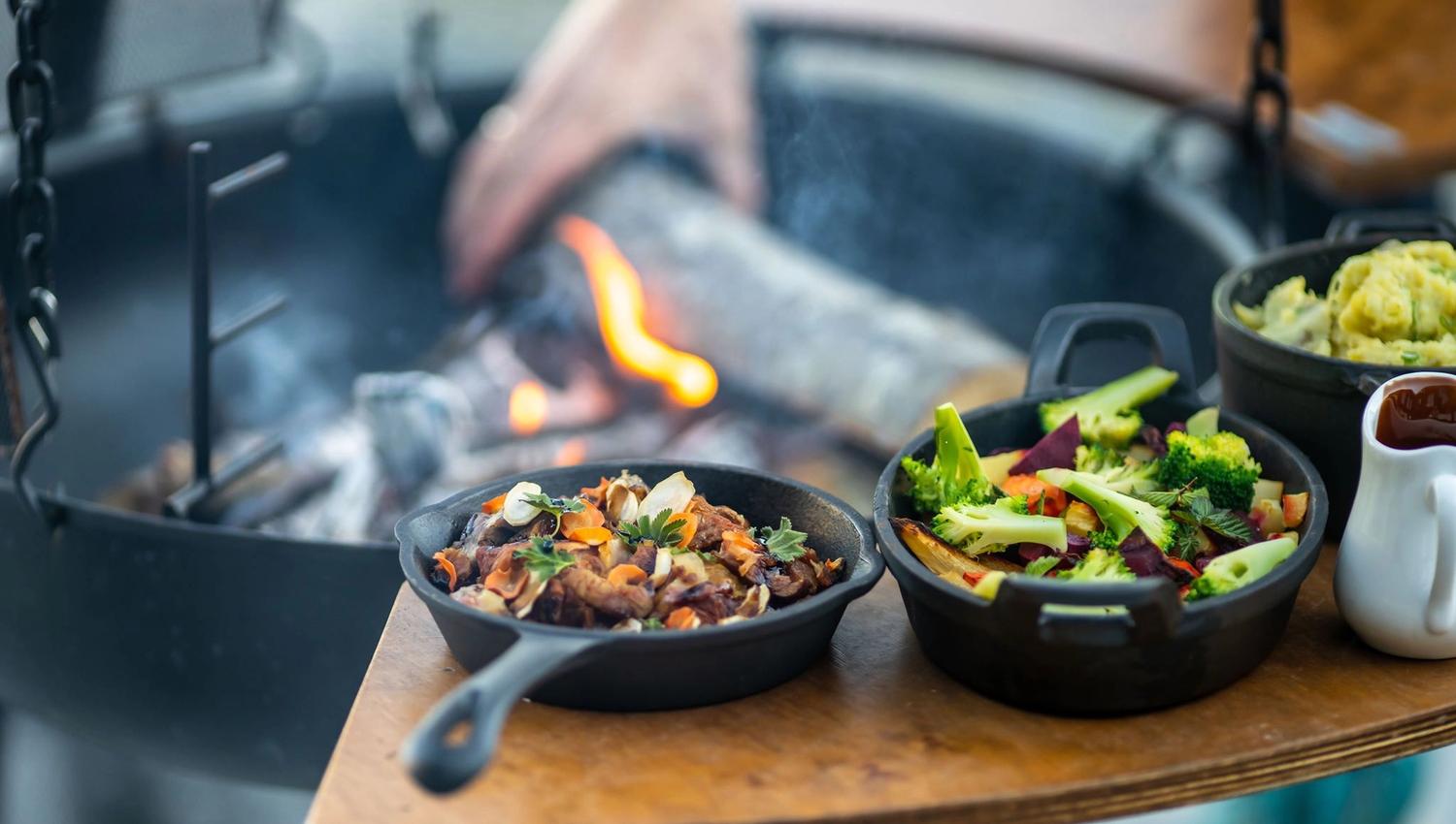 Delicious grilled dishes cooked over an open fire, served with fresh, local ingredients.