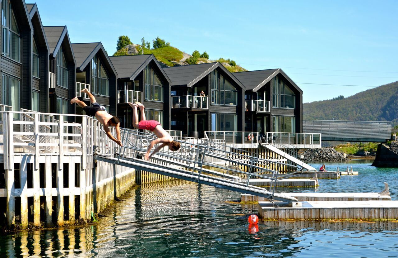 summer photo, two people jumping into the sea.