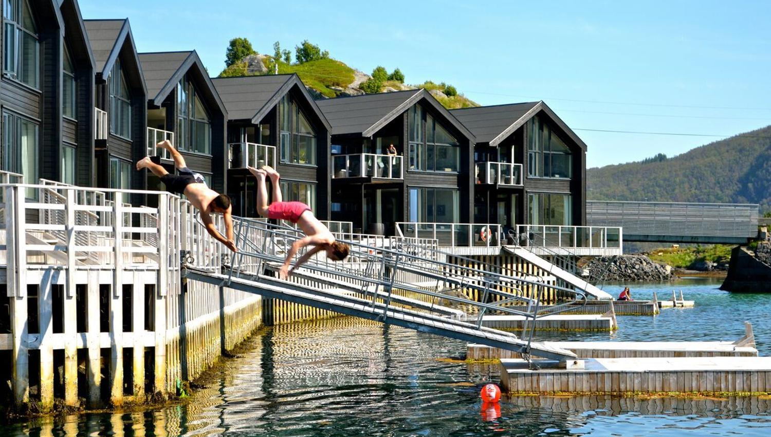 summer photo, two people jumping into the sea.