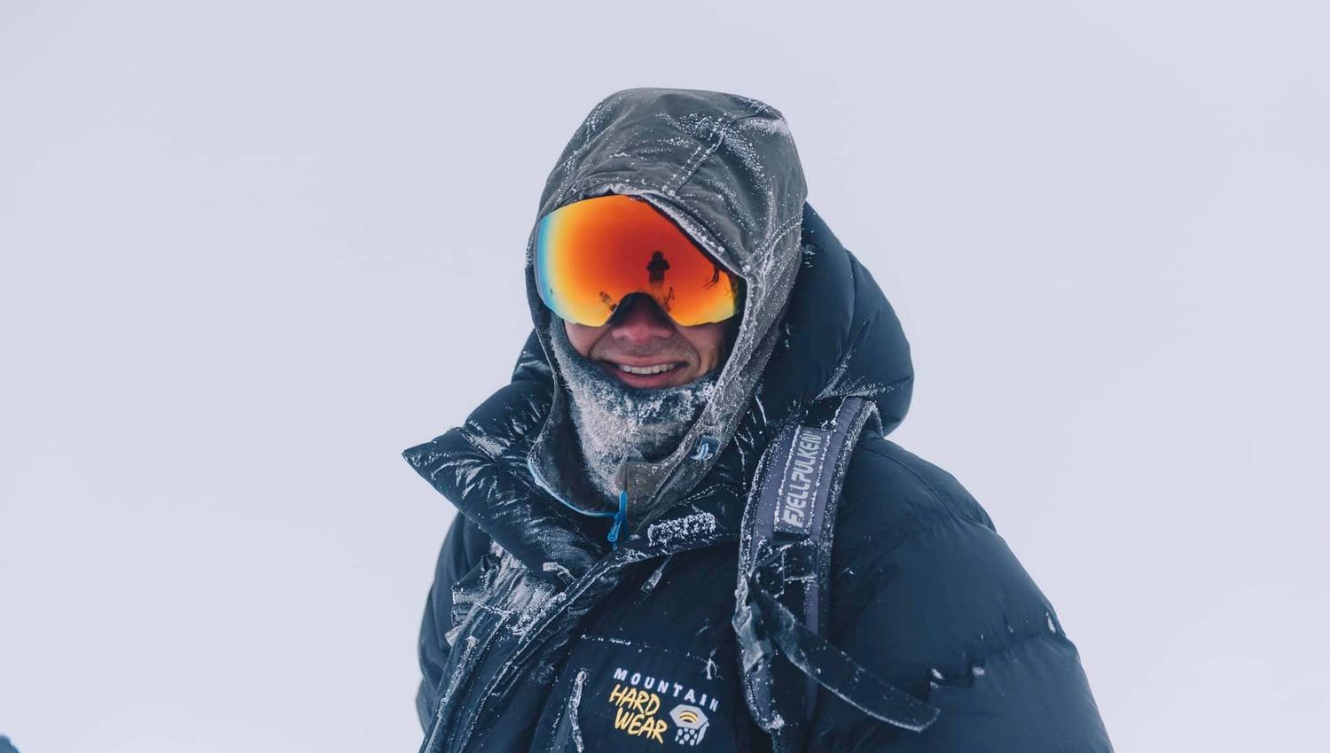 A person with skiing goggles and clothes covered with frost