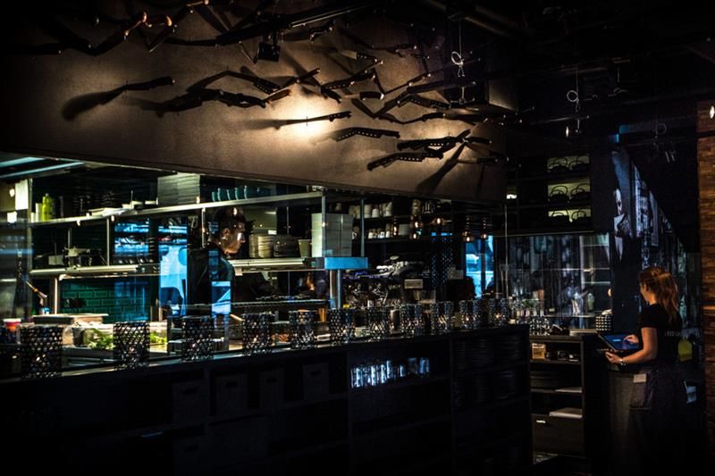 Interior of bar area with two waiters.