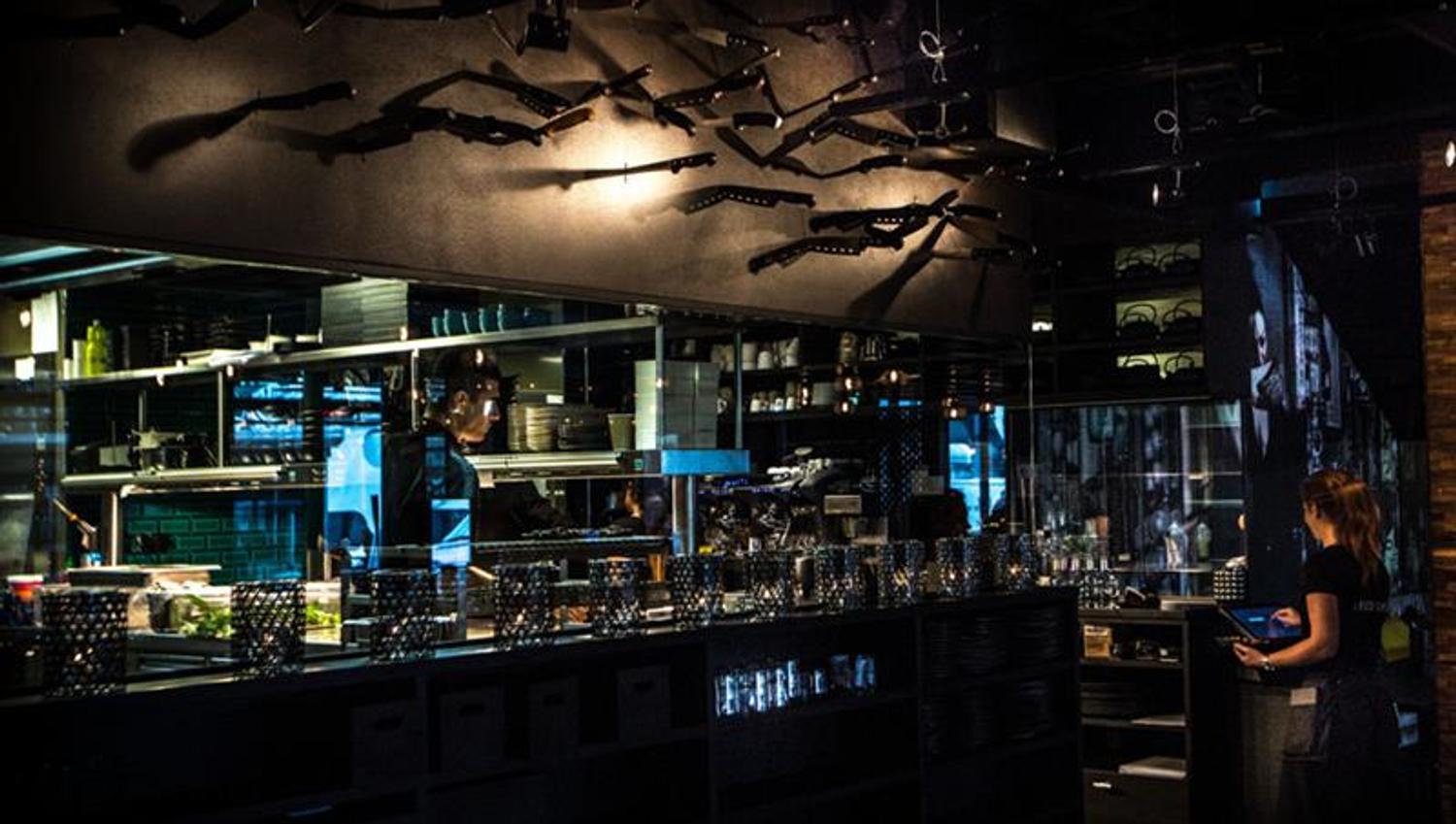 Interior of bar area with two waiters.