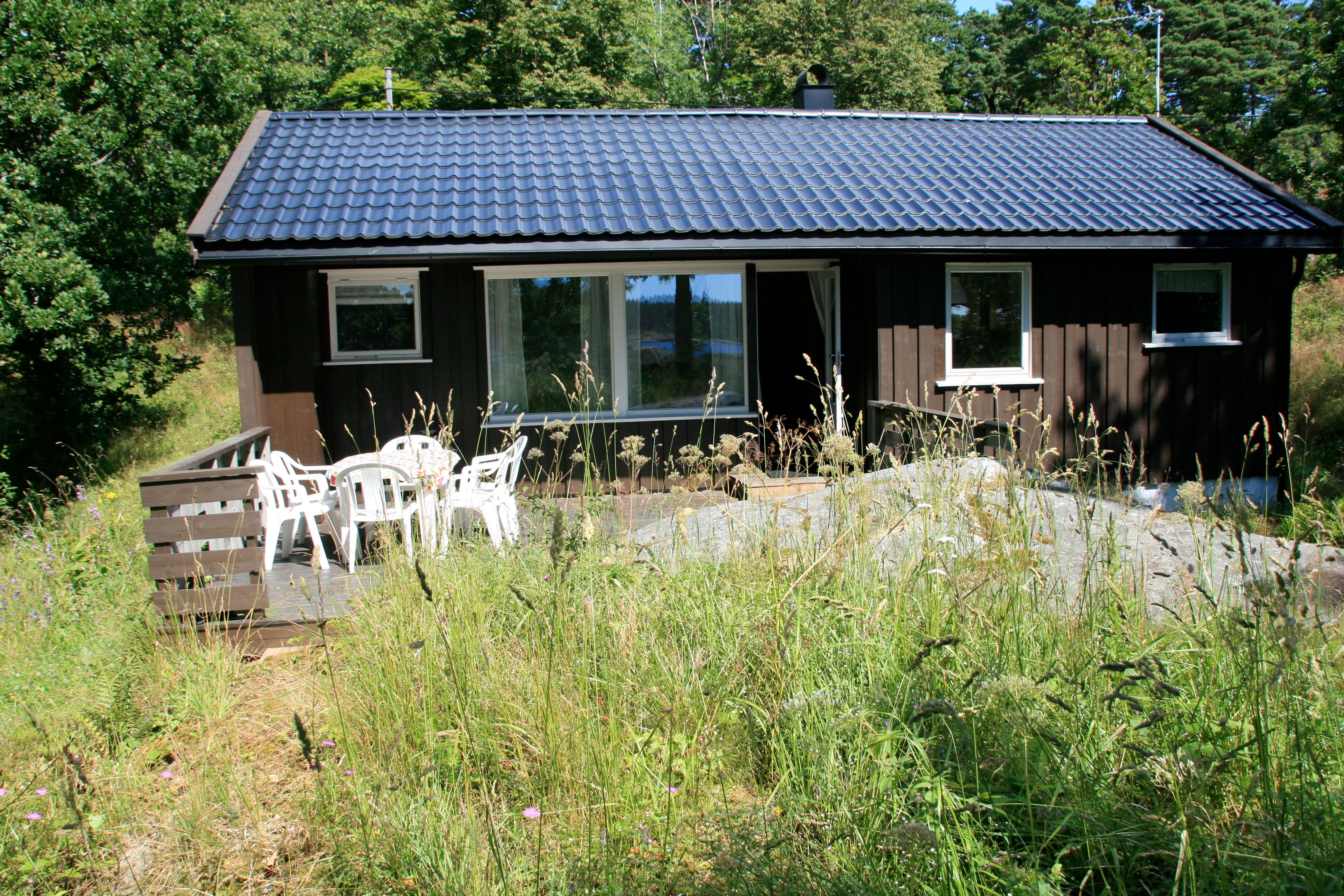 liten brun utleiehytte på Sandaa på Tromøy