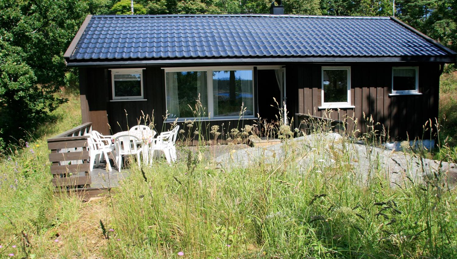 liten brun utleiehytte på Sandaa på Tromøy