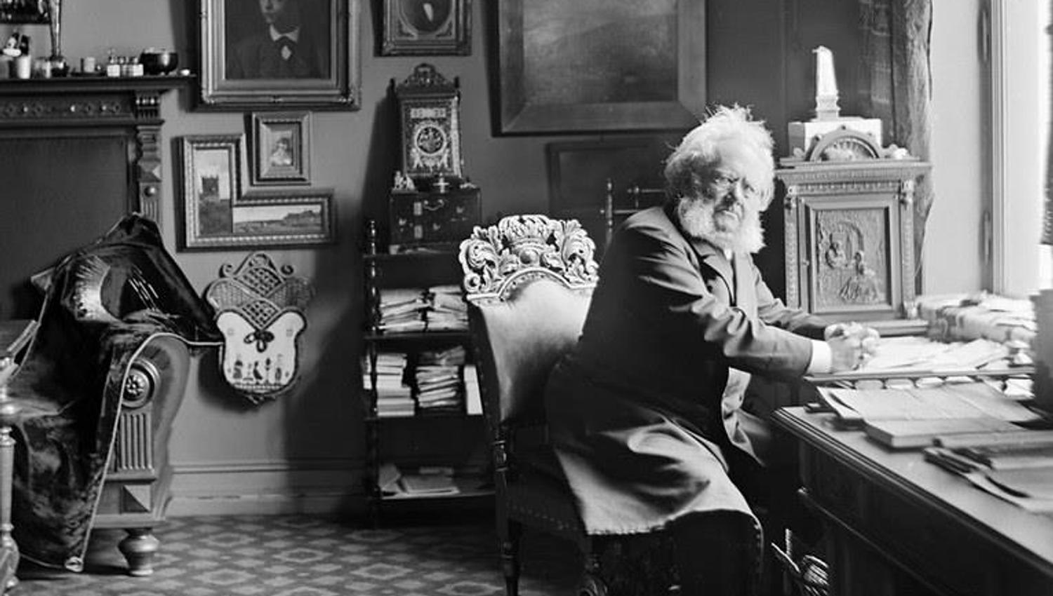 Black and white photograph of Henrik Ibsen at his desk