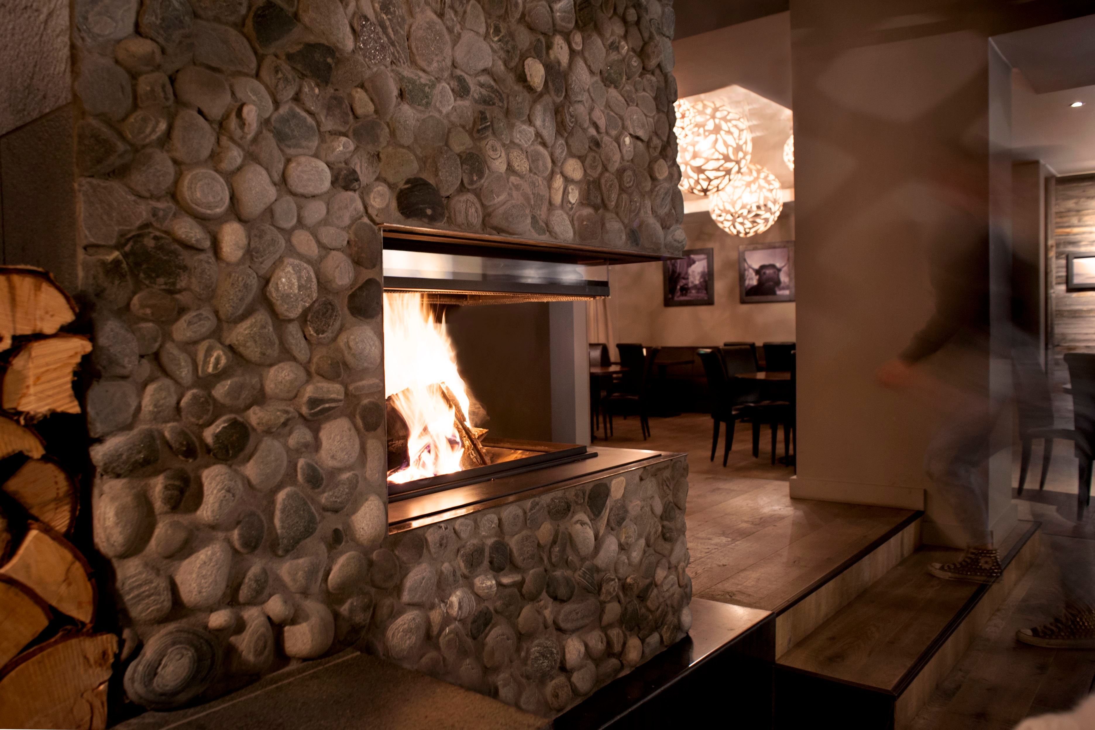 Fireplace inside a wall decorated with stone
