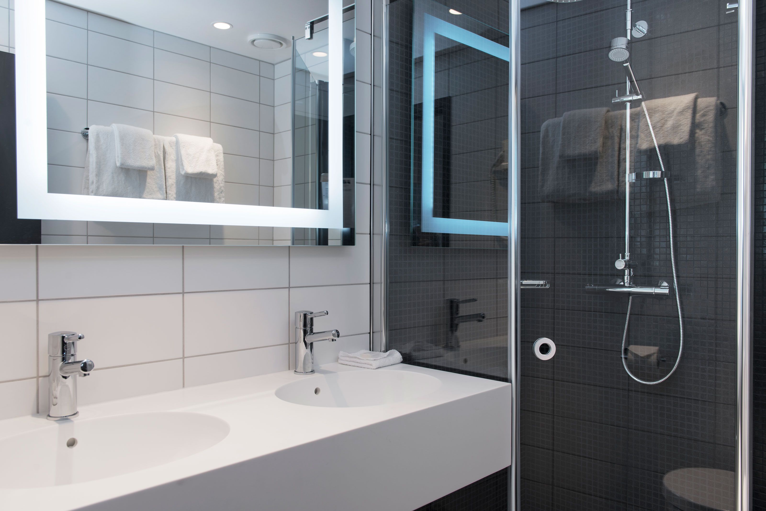 modern bathroom with two sinks and a shower