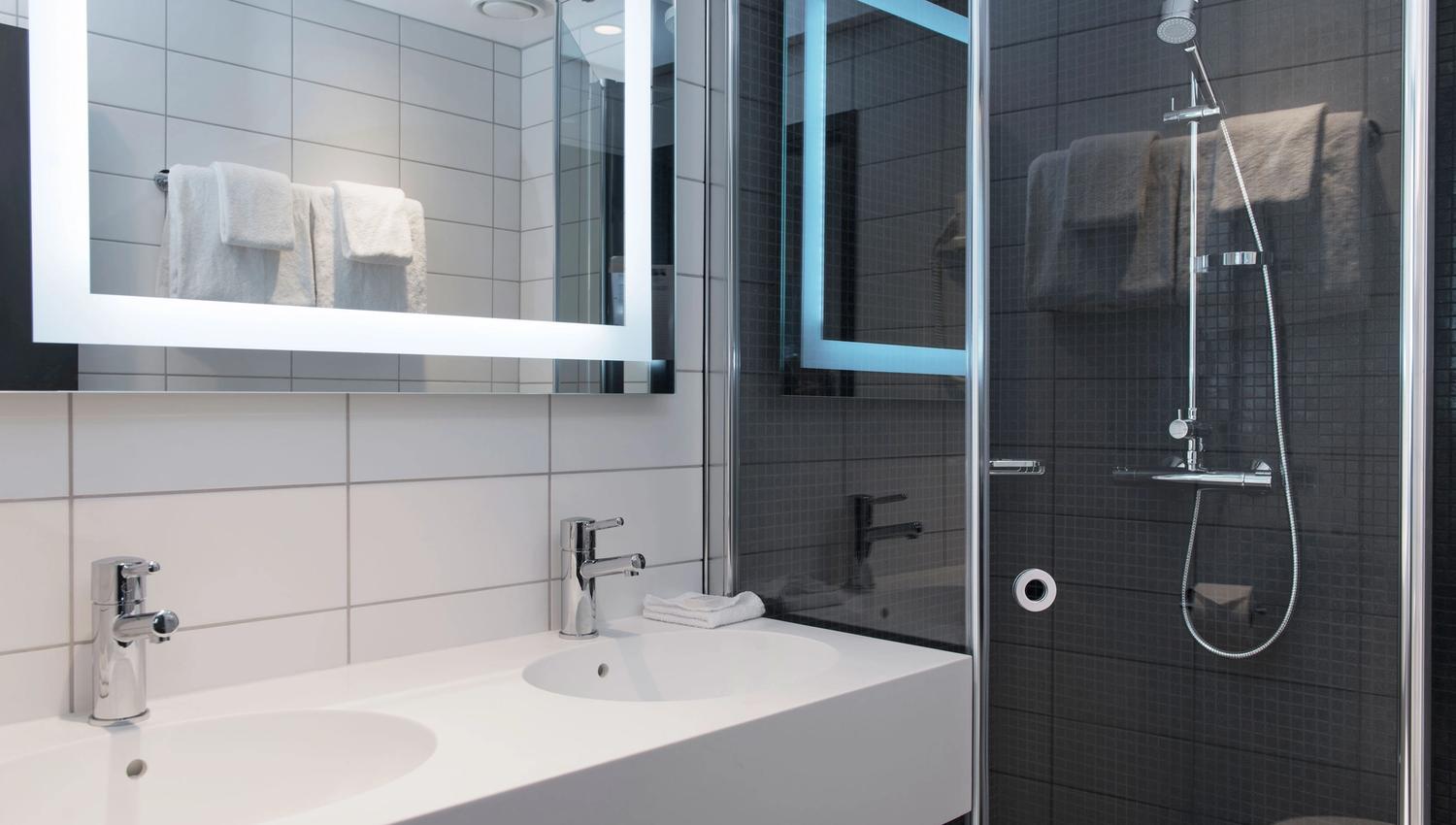 modern bathroom with two sinks and a shower