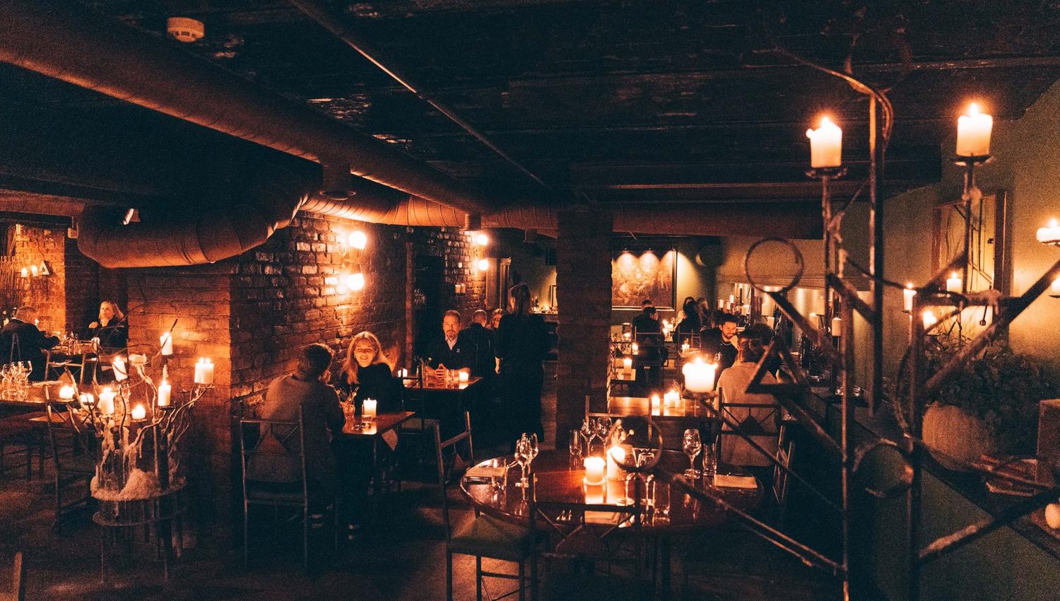 People sitting and dining in a cellar restaurant