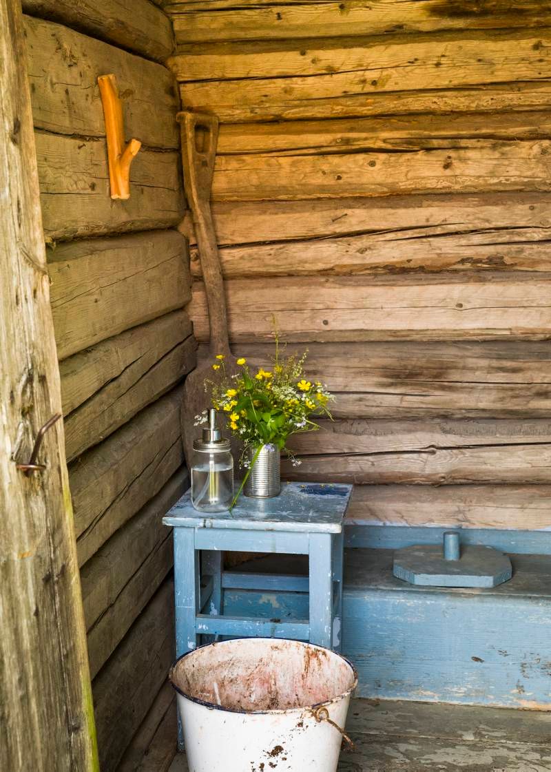 an outdoor toilet, decorated with flowers