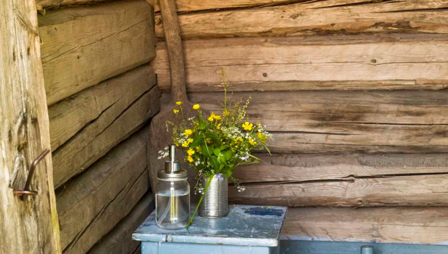 an outdoor toilet, decorated with flowers