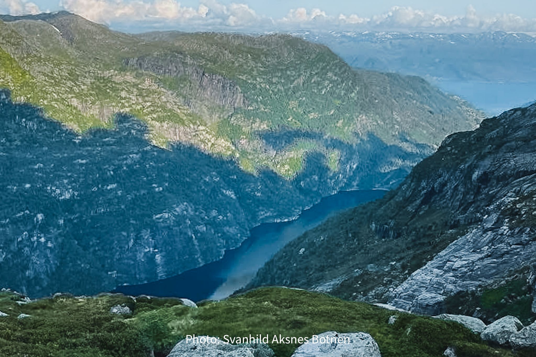 Deep fjord seen from the mountains in Hardanger, Norway, showcasing dramatic cliffs and pristine nature
