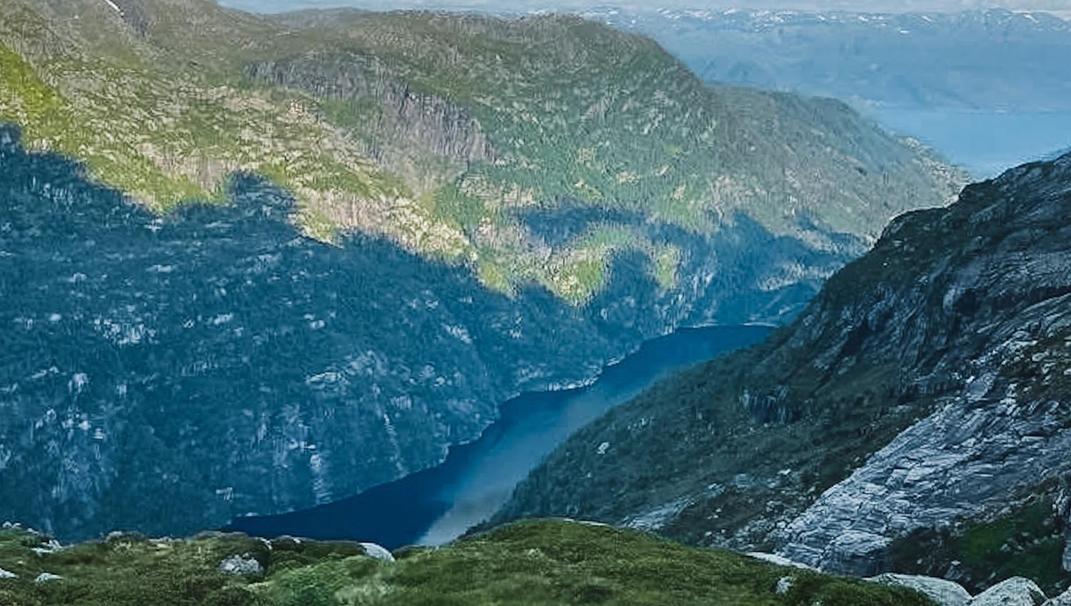 Deep fjord seen from the mountains in Hardanger, Norway, showcasing dramatic cliffs and pristine nature